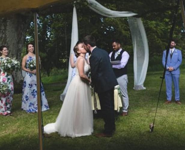Bride and groom under marquee