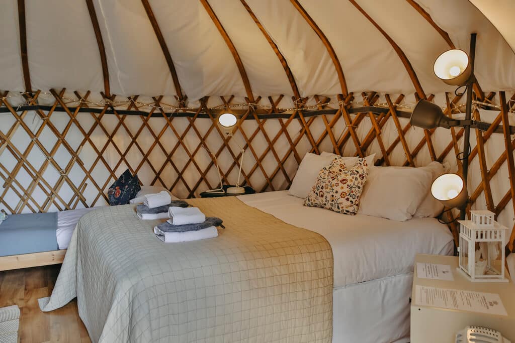 Interior of yurt accommodation, lamps, big bed