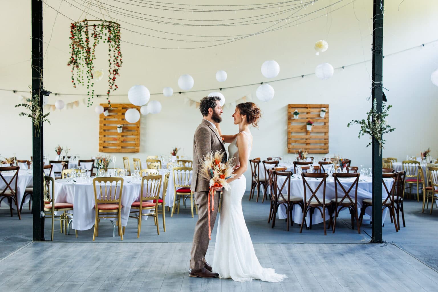 Bride and groom look in each other eyes on dance floor at slane rock venue
